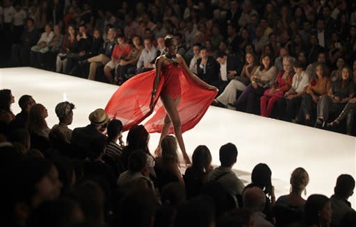 A model wears jewelry by Colombian designer Nelly Rojas at the Cali Exposhow fashion week in Cali, Colombia, Thursday, Oct. 18, 2012. (AP Photo/Fernando Vergara)