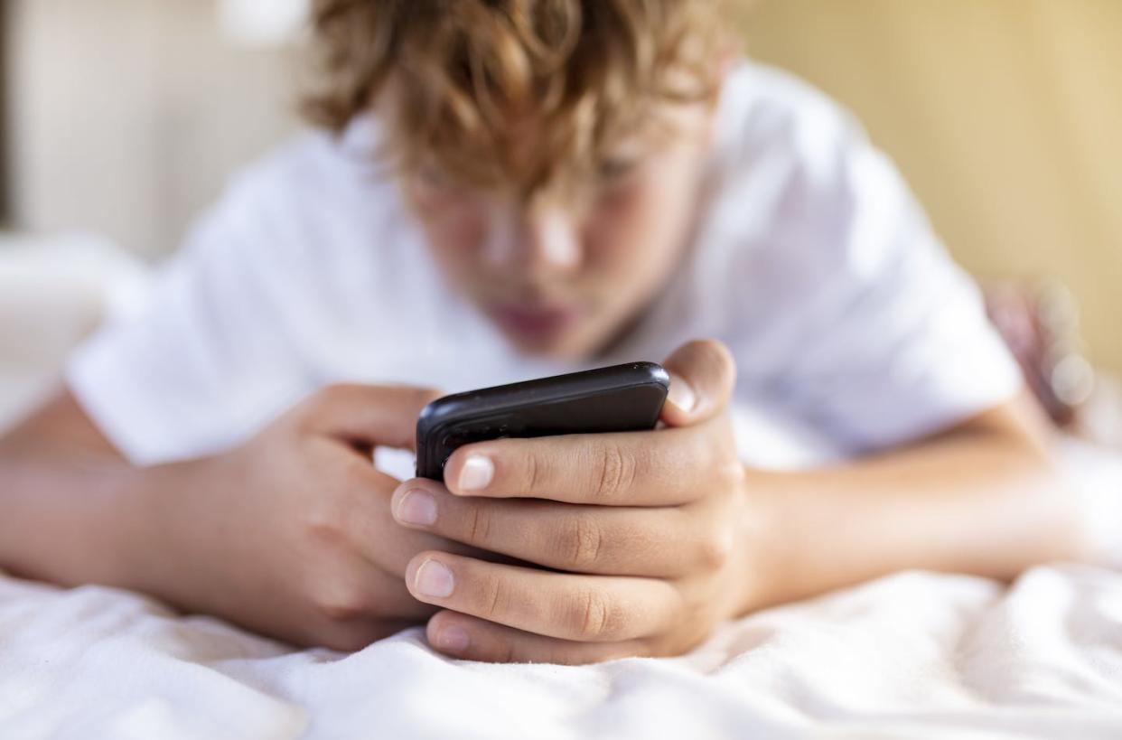 Pornography presents persistent risks for adolescents. <a href="https://www.gettyimages.com/detail/photo/teenager-boy-is-using-smartphone-at-home-in-bed-royalty-free-image/1353071585?phrase=teens%20iphones%20school&adppopup=true" rel="nofollow noopener" target="_blank" data-ylk="slk:EMS-FORSTER-PRODUCTIONS via Getty Images;elm:context_link;itc:0;sec:content-canvas" class="link ">EMS-FORSTER-PRODUCTIONS via Getty Images</a>