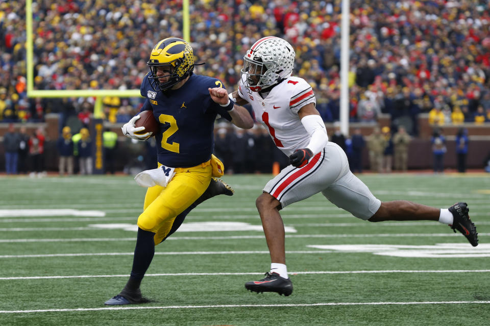 Michigan quarterback Shea Patterson (2) tries to avoid Ohio State cornerback Jeff Okudah (1) in the first half of an NCAA college football game in Ann Arbor, Mich., Saturday, Nov. 30, 2019. (AP Photo/Paul Sancya)