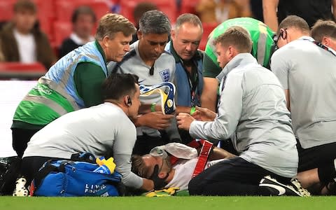 England's Luke Shaw (centre) receives treatment after picking up an injury during the UEFA Nations League, League A Group Four match at Wembley Stadium - Credit: PA