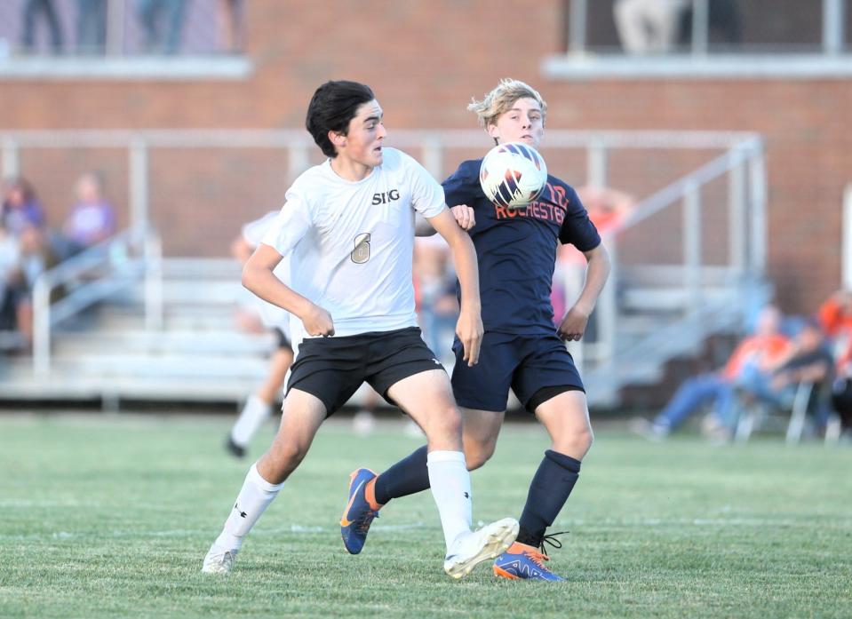 Rochester's Brenden McArdle vies for the ball against Sacred Heart-Griffin's Gavin Hayes during a Central State Eight Conference boys soccer match on Tuesday, Sept. 19, 2023.
