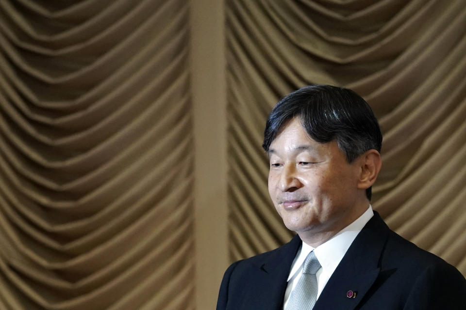 Japan's Emperor Naruhito stands to open formally an extraordinary session at the upper house of parliament in Tokyo Thursday, Aug. 1, 2019. Naruhito delivered his first opening speech since ascending to the Chrysanthemum Throne on May 1. (AP Photo/Eugene Hoshiko)