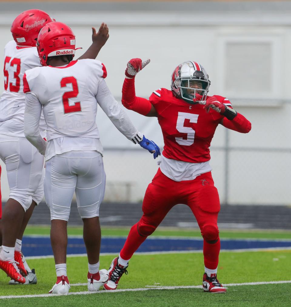 East linebacker Jaden Bell celebrates the Dragons' goal-line stand late in the fourth quarter of their 14-13 win over Youngstown Chaney on Friday in Akron.