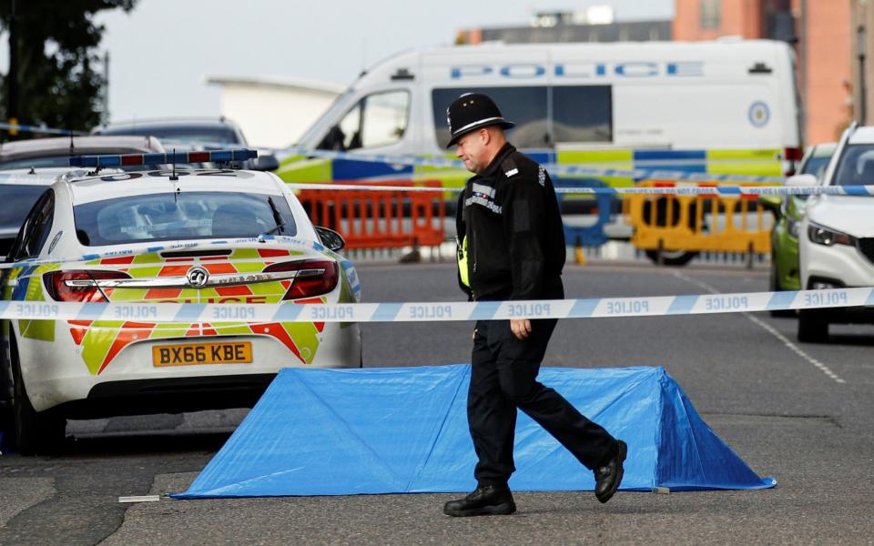 A police officer is seen near the scene of reported stabbings in Birmingham on Sunday morning - REUTERS/Phil Noble