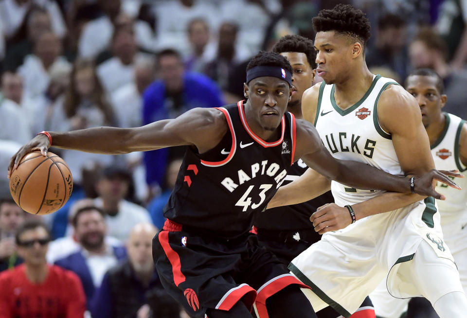 Toronto Raptors forward Pascal Siakam (43) tries to keep Milwaukee Bucks forward Giannis Antetokounmpo (34) at bay during the first half in Game 1 of the NBA basketball playoffs Eastern Conference final in Milwaukee on Wednesday, May 15, 2019. (Frank Gunn/The Canadian Press via AP)