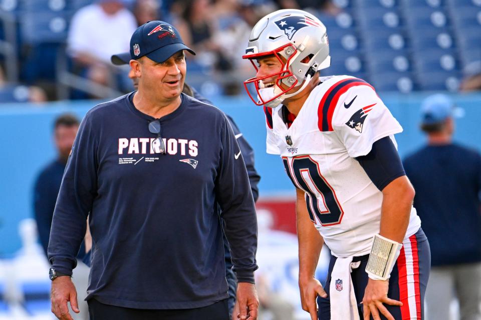 New England Patriots offensive coordinator quarterbacks Bill O'Brien stands near quarterback Mac Jones (10) before an NFL preseason football game against the Tennessee Titans Saturday, Aug. 26, 2023, in Nashville, Tenn. (AP Photo/John Amis)