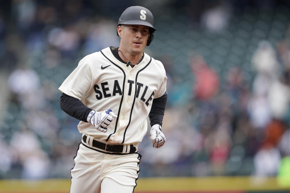 Seattle Mariners' Dylan Moore rounds the bases after he hit a solo home run against the Los Angeles Angels during the third inning of the first baseball game of a doubleheader, Saturday, June 18, 2022, in Seattle. (AP Photo/Ted S. Warren)