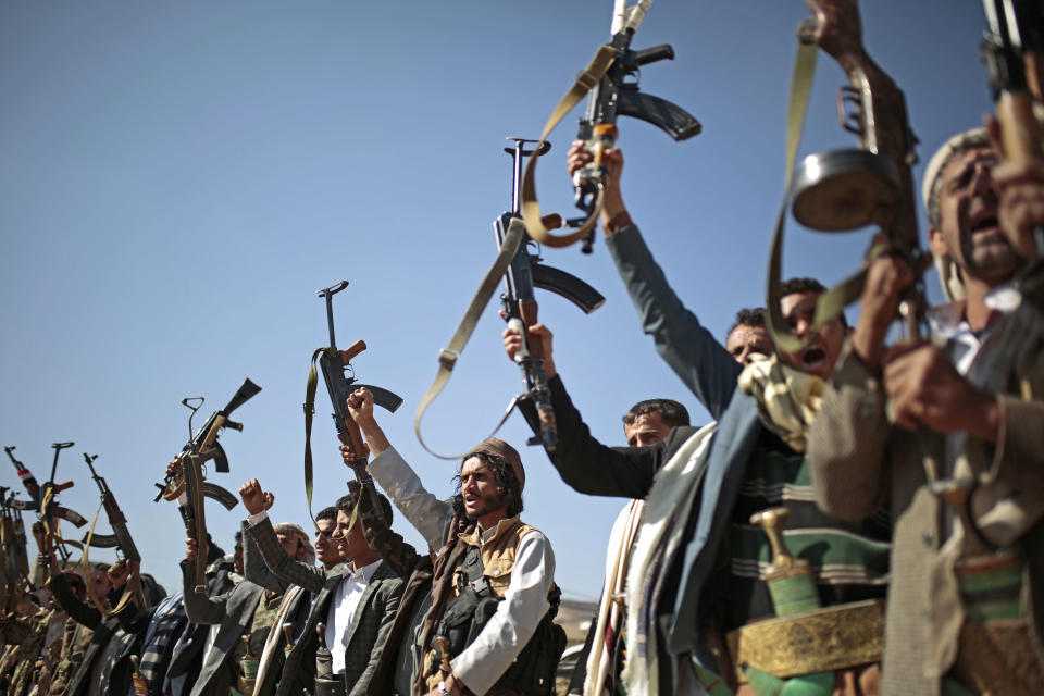 FILE - In this Dec. 13, 2018, file photo, tribesmen loyal to Houthi rebels hold up their weapons as they attend a gathering to show their support for the ongoing peace talks in Sanaa, Yemen. The United Arab Emirates, one of the most powerful parties in Yemen’s war, has begun to draw down its forces in past weeks in 2019, leaving the Saudi-led coalition with a weakened ground presence and fewer tactical options. (AP Photo/Hani Mohammed, File)
