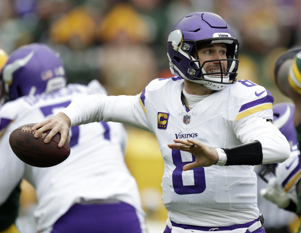 FILE - Minnesota Vikings quarterback Kirk Cousins (8) looks to pass during the first half of an NFL football game against the Green Bay Packers, Oct. 29, 2023, in Green Bay, Wis. Cousins and the Vikings have entered another crossroad offseason revolving around the club’s still-undrawn roadmap at quarterback. (AP Photo/Matt Ludtke, File)