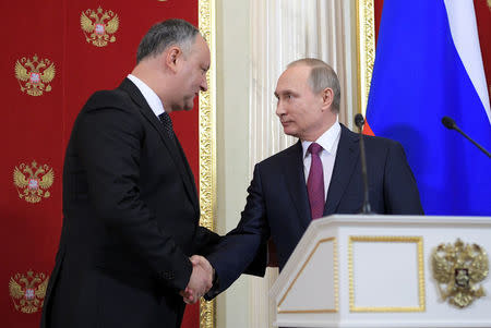 Russian President Vladimir Putin (R) shakes hands with his Moldovan counterpart Igor Dodon during a news conference at the Kremlin in Moscow, Russia, January 17, 2017. Sputnik/Alexei Druzhinin/Kremlin via REUTERS