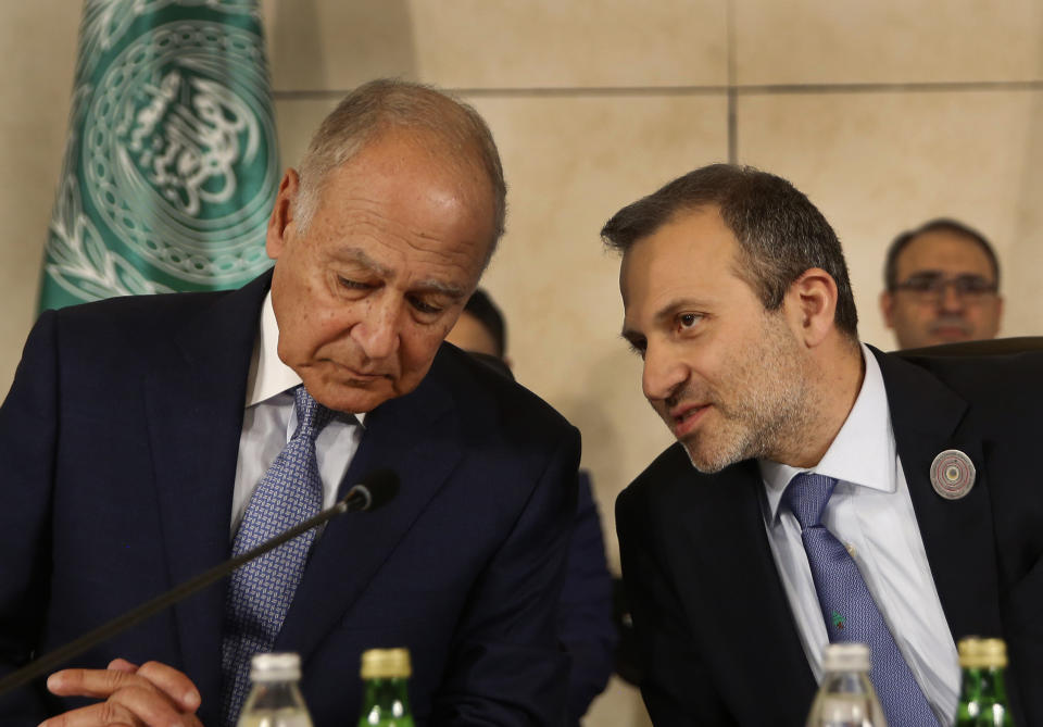 Lebanese Prime Minister Gibran Bassil, right, speaks with Arab League Secretary-General, Ahmed Aboul Gheit, left, during the opening session of the Arab foreign ministers meeting ahead of a weekend Arab Economic Summit, in Beirut, Lebanon, Friday, Jan. 18, 2019. The Arab Economic and Social Development Summit, or AESD, is being held in Lebanon for the first time amid sharp divisions in the country and among Arab countries. (AP Photo/Hussein Malla)