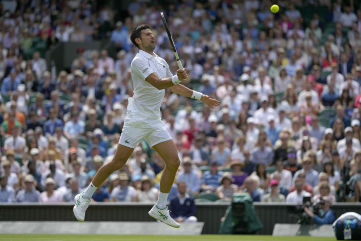 Serbia's Novak Djokovic returns the ball to Australia's Thanasi Kokkinakis during their singles tennis match on day three of the Wimbledon tennis championships in London, Wednesday, June 29, 2022. (AP Photo/Alastair Grant)