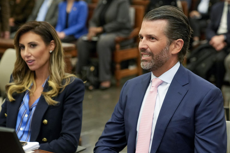 Donald Trump Jr., right, waits to testify in New York Supreme Court, Wednesday, Nov. 1, 2023, in New York. Donald Trump's eldest sons are set to testify in the New York civil fraud case that threatens their company's future, but a demand for daughter Ivanka's testimony is being challenged. (AP Photo/Seth Wenig)