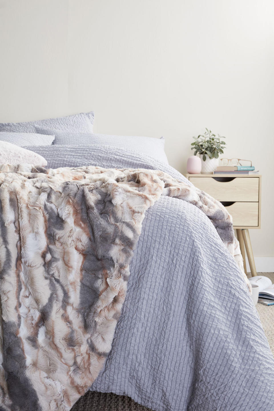 Coles will also be selling a $19.99 faux fur throw and a machine washable wool blend queen size doona for $54.99. Photo: Supplied