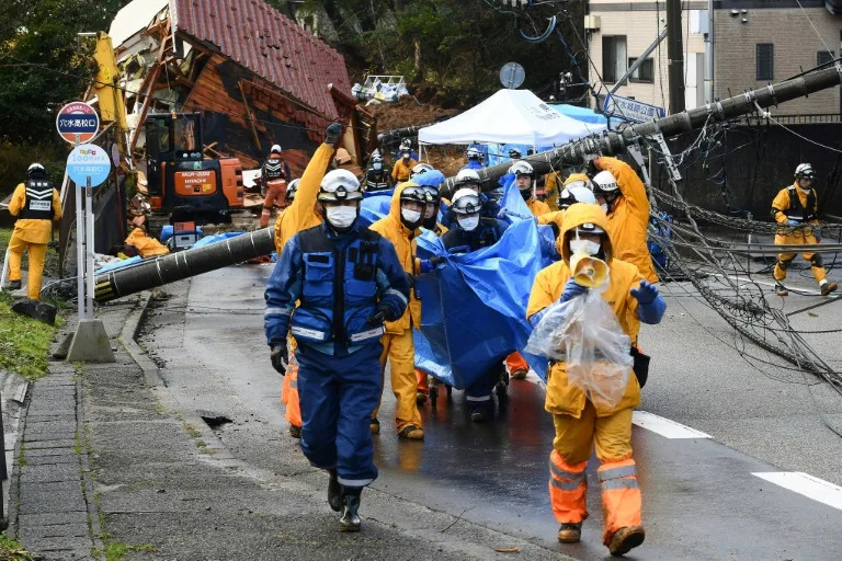 Rescuers carry away the body of a landslide victim (Toshifumi KITAMURA)