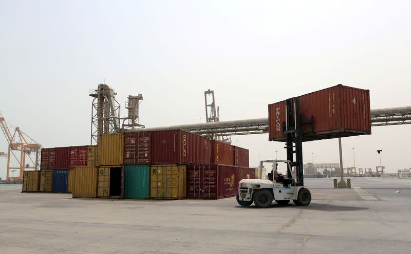 FILE PHOTO: A forklift carries a shipping container at the Red Sea port of Hodeidah