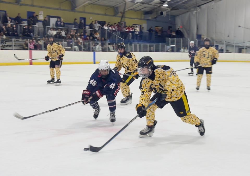 SJV's Nick Kasich makes a move as Wall's Jack Findley tries to poke the puck loose.