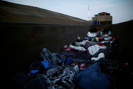 FILE PHOTO: Central American migrants, moving in a caravan through Mexico, travel in an open wagon of a freight train after stopping it on the rail line, in Guanajuato state, Mexico April 17, 2018. REUTERS/Edgard Garrido/File Photo