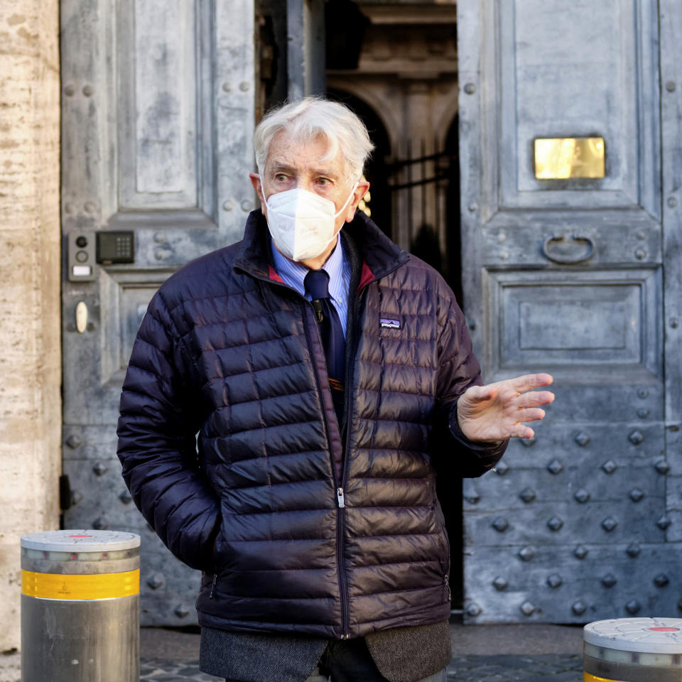 Corrado Augias, a longtime journalist for La Repubblica daily and onetime European Parliamentarian for Italy’s center-left, stands in front of the entrance of French embassy to Italy, in Rome, Monday, Dec. 14, 2020. Augias went to the embassy to return his Legion of Honor award to France to protest that Egyptian President Abdel-Fattah el-Sissi was given the prize despite his government's human rights abuses. (Mauro Scrobogna/LaPresse via AP)