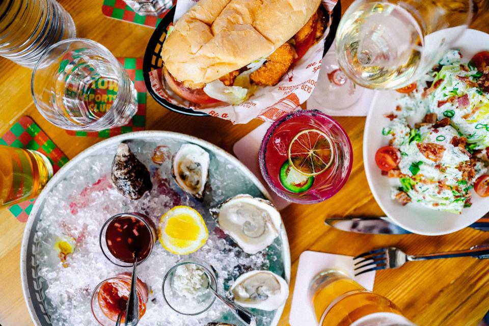 The food menu at Uptown Sports Club includes raw East Coast oysters, po' boys and a wedge salad.