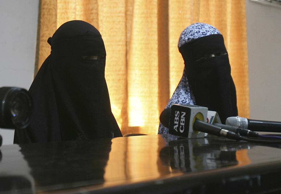 Filipino sisters and independent filmmakers Nadioua Bansil, left, and Linda Bansil, sit following a press conference at the Western Mindanao Command in Zamboanga city, southern Philippines Friday, Feb. 21, 2014. Two Filipino sisters kidnapped by Muslim extremists eight months ago escaped their captors in the jungles of the southern Philippines and told authorities they were kept in isolation in a hut on a meager diet. (AP Photo)