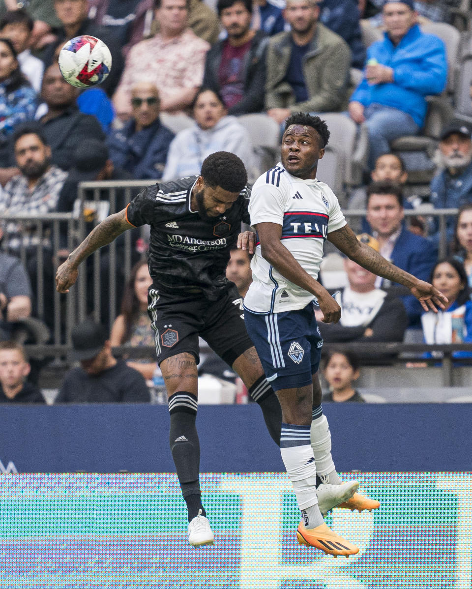 Vancouver Whitecaps' Javain Brown, right, flicks the ball past Houston Dynamo's Micael during the first half of an MLS soccer match Wednesday, May 31, 2023, in Vancouver, British Columbia. (Rich Lam/The Canadian Press via AP)