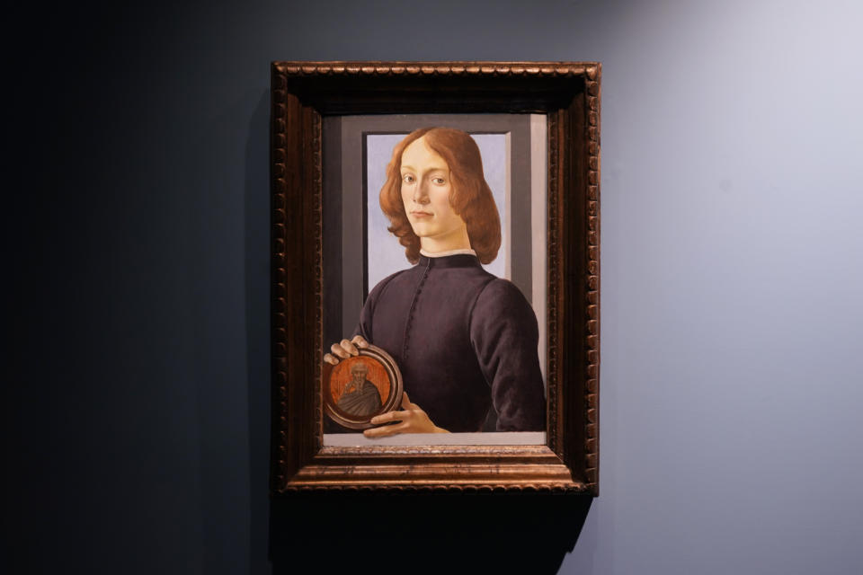 Sandro Botticelli's 15th-century painting called "Young Man Holding a Roundel" is displayed at Sotheby's on Sept. 23, 2020, in New York. The painting will go on auction next year and art watchers will be seeing if it fetches more than its eye-watering $80 million estimate, despite the pandemic. Botticelli’s 15th-century portrait of a nobleman in “Young Man Holding a Roundel” is the highlight of Sotheby’s Masters Week sale series in New York in January. (AP Photo/Seth Wenig)