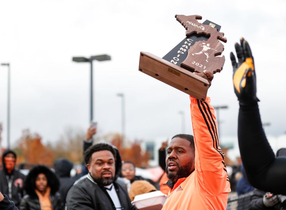 Belleville head coach Jermain Crowell and players celebrates 12-7 win over Dearborn Fordson at Belleville High School in Belleville on Saturday, Nov. 13, 2021.