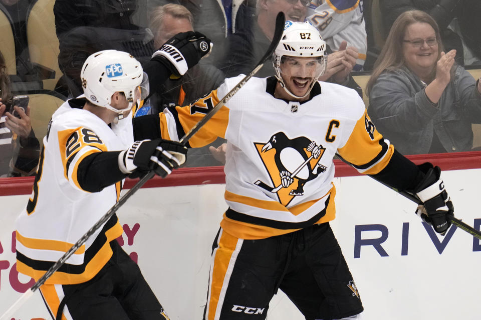 Pittsburgh Penguins' Sidney Crosby (87) celebrates his goal against the Buffalo Sabres with Marcus Pettersson during the third period of an NHL hockey game in Pittsburgh, Saturday, Dec. 10, 2022. (AP Photo/Gene J. Puskar)