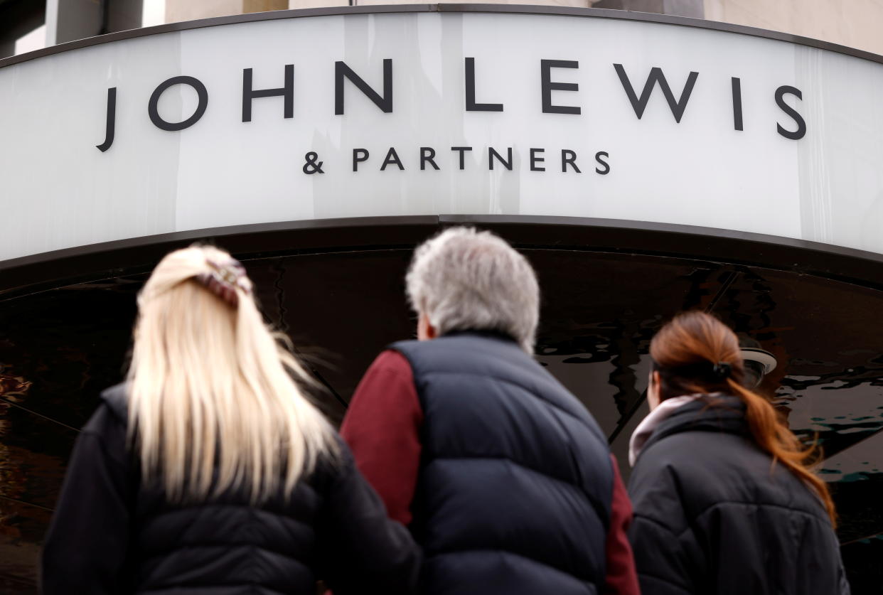 People walk past a temporarily closed John Lewis department store on Oxford Street in London, Britain, March 24, 2021. REUTERS/John Sibley