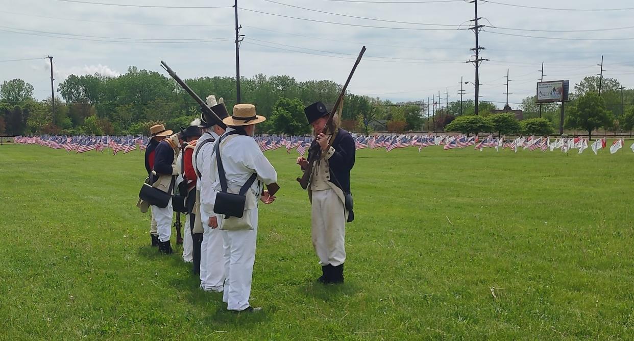 War of 1812 re-enactors perform a drill demonstration during a Living History event at the River Raisin National Battlefield Park.