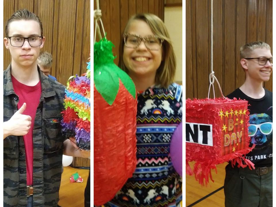 Three kids with their birthday pinatas.