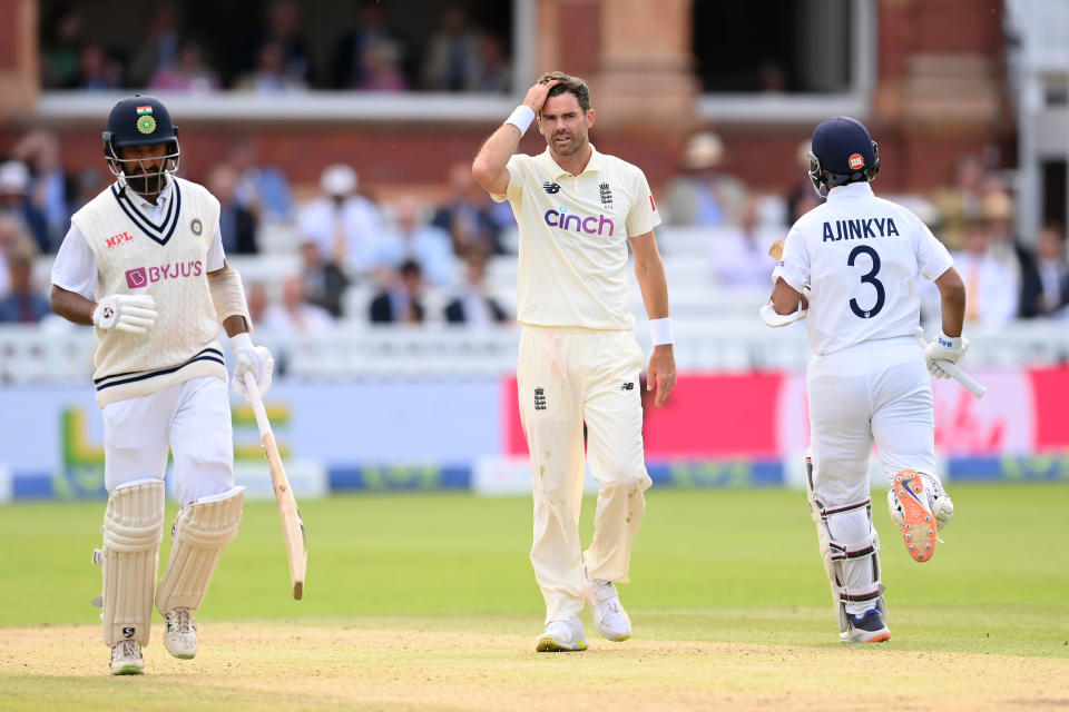 LONDON, ENGLAND - AUGUST 15: Jimmy Anderson of England looks on as Cheteshwar Pujara (L) and Ajinkya Rahane of India take another run during the Second LV= Insurance Test Match: Day Four between England and India at Lord's Cricket Ground on August 15, 2021 in London, England. (Photo by Mike Hewitt/Getty Images)