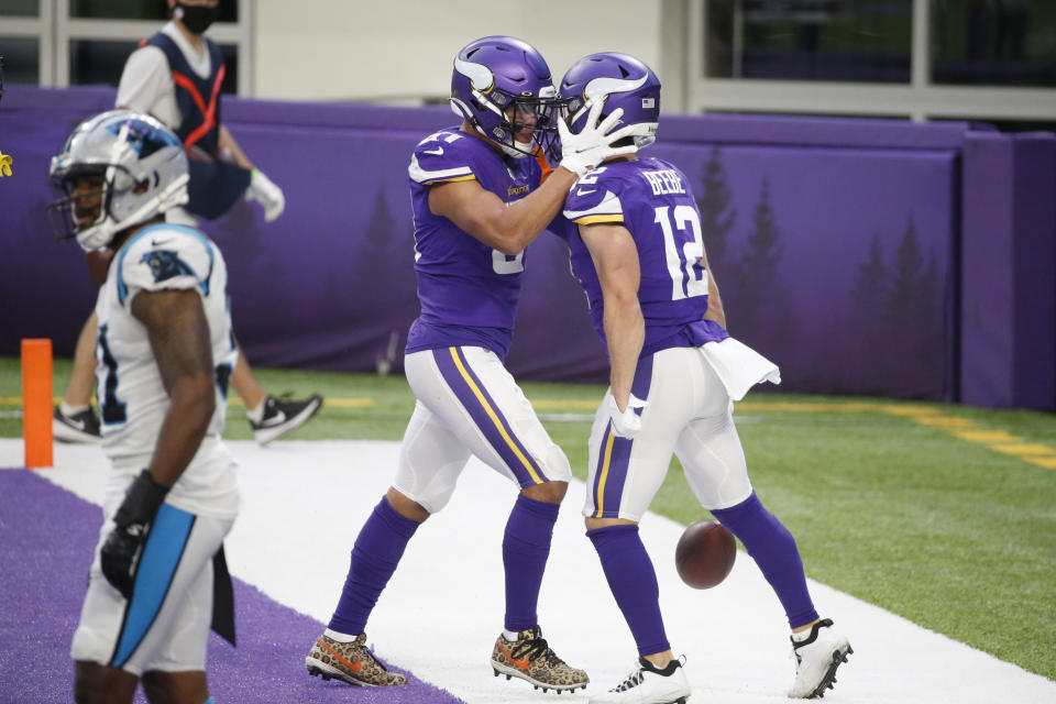 Minnesota Vikings wide receiver Chad Beebe (12) celebrates with teammate Bisi Johnson, left, after catching a 10-yard touchdown pass during the second half of an NFL football game against the Carolina Panthers, Sunday, Nov. 29, 2020, in Minneapolis. The Vikings won 28-27. (AP Photo/Bruce Kluckhohn)