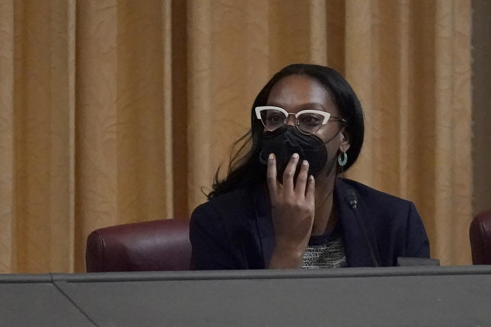 FILE - Task Force Chair Kamilah Moore listens to public comment during a meeting by the Task Force to Study and Develop Reparation Proposals for African Americans in Oakland, Calif., on Dec. 14, 2022. California's first-in-the-nation reparations task force wraps up its historic work Thursday, June 29, 2023, with the formal submission to lawmakers of a final report that includes dozens of recommendations on how the state can apologize and compensate Black residents for decades of discriminatory practices and policies. (AP Photo/Jeff Chiu, File)