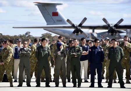 International and Australian aircrews involved in the search for missing Malaysia Airlines plane MH370 prepare for an official photograph as they stand on the tarmac at the Royal Australian Air Force (RAAF) Pierce Base in Bullsbrook, near Perth, April 29, 2014. REUTERS/Richard Polden