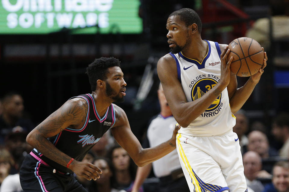 MIAMI, FLORIDA - FEBRUARY 27:  Kevin Durant #35 of the Golden State Warriors is defended by Derrick Jones Jr. #5 of the Miami Heat at American Airlines Arena on February 27, 2019 in Miami, Florida. NOTE TO USER: User expressly acknowledges and agrees that, by downloading and or using this photograph, User is consenting to the terms and conditions of the Getty Images License Agreement. (Photo by Michael Reaves/Getty Images)