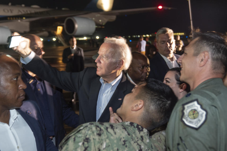 President Joe Biden takes a selfie with U.S. troops after landing on Air Force One, Wednesday, Nov. 16, 2022, at Andersen Air Force Base, Guam. (AP Photo/Alex Brandon)