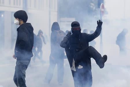 A protestors kicks a tear gas canister during a demonstration to protest the government's proposed labour law reforms in Nantes, France, May 26, 2016. REUTERS/Stephane Mahe