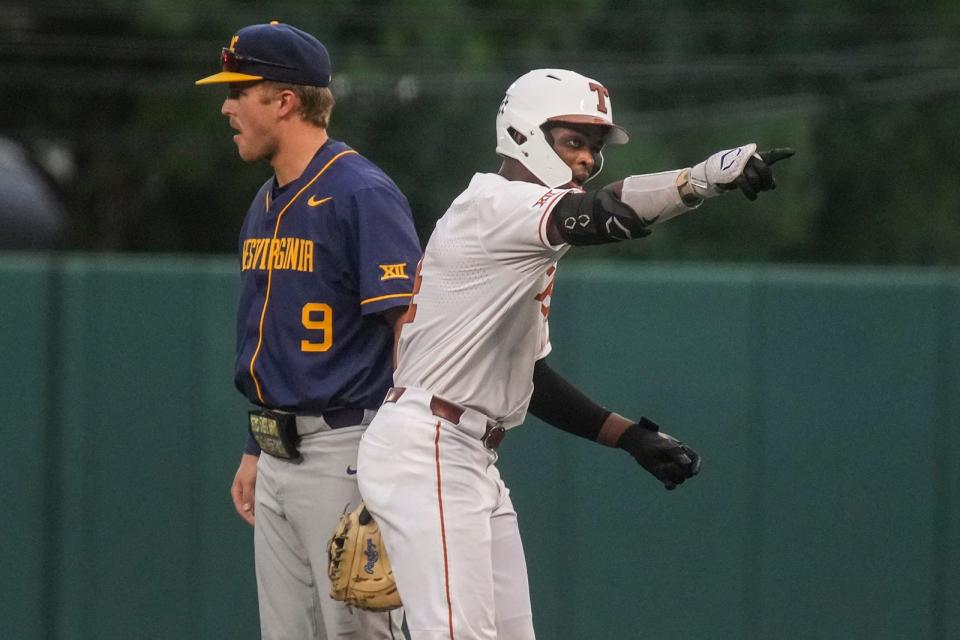 Texas outfielder Porter Brown cheers on in support during the Longhorns' 10-4 win over West Virginia at UFCU Disch-Falk Field on Friday night. The Longhorns, who have won the first two of their three games in the series, can claim a share of the Big 12 regular-season championship if they complete the series sweep on Saturday.