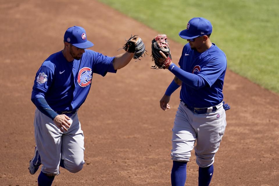 Chicago Cubs shortstop Eric Sogard, left, is congratulated by Cubs third baseman Ildemaro Vargas after Sogard's inning ending out against the Cleveland Indians during the second inning of a spring training baseball game Thursday, March 18, 2021, in Goodyear, Ariz. (AP Photo/Ross D. Franklin)