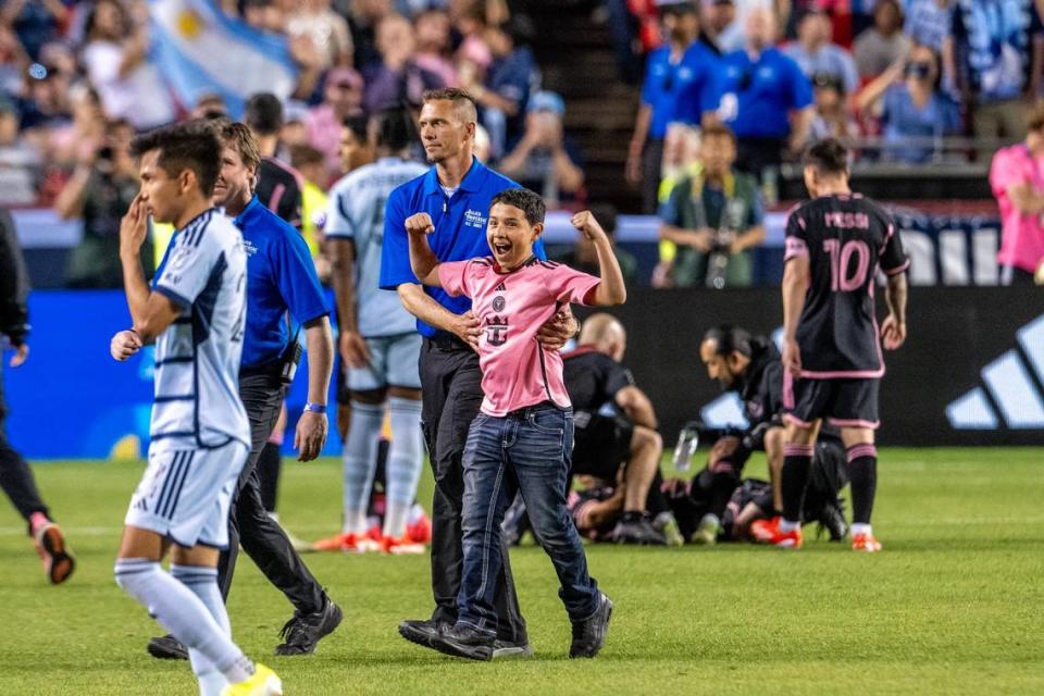 A young Inter Miami fan cheers to the crowd after making it onto the field to take a photo with forward Lionel Messi (10) in the second half during an MLS game against Sporting Kansas City at GEHA Field at Arrowhead Stadium on Saturday, April 13, 2024, in Kansas City.