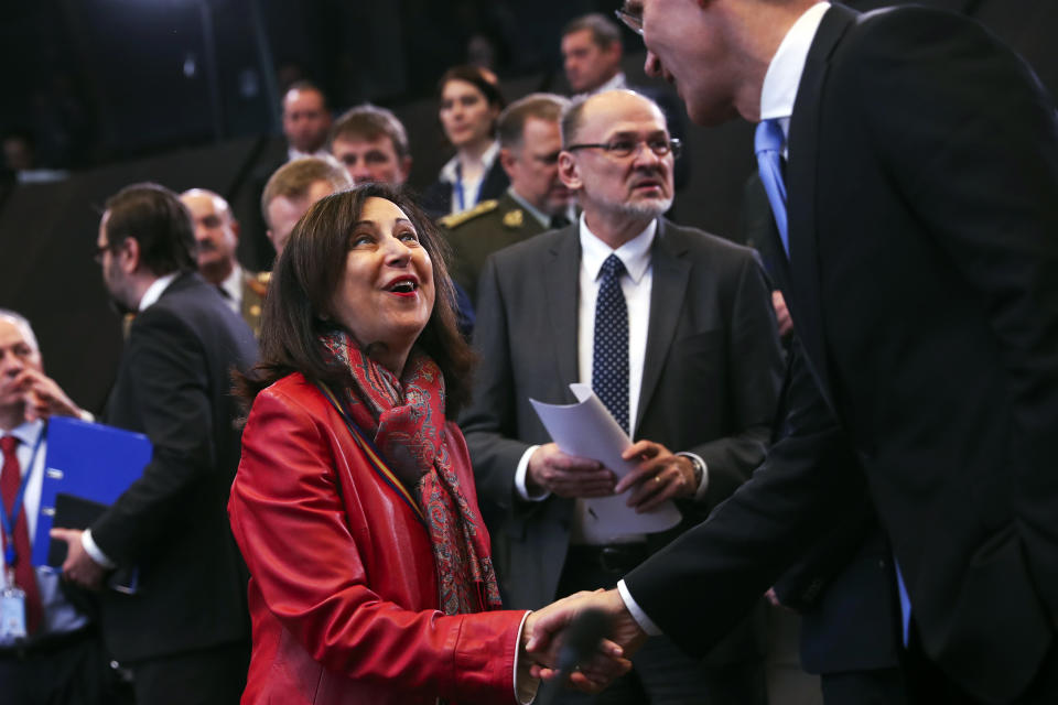 Spain's Defense Minister Margarita Robles, left, shakes hands with NATO's Secretary General Jens Stoltenberg during the second day of a NATO defence ministers meeting at NATO headquarters in Brussels, Thursday, Feb. 14, 2019. NATO defense ministers are discussing the future of the alliance's operation in Afghanistan and how best to use its military presence to support political talks aimed at ending the conflict. (AP Photo/Francisco Seco)