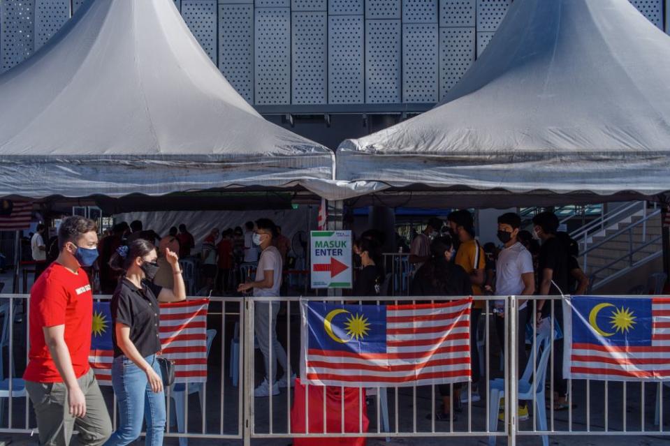 People queue as they wait to receive their Covid-19 jab at the Axiata Arena in Bukit Jalil September 23, 2021. — Picture by Shafwan Zaidon