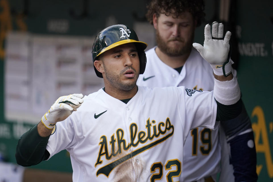 Oakland Athletics' Ramon Laureano is congratulated by teammates after hitting a home run against the Toronto Blue Jays during the fifth inning of a baseball game in Oakland, Calif., Monday, July 4, 2022. (AP Photo/Jeff Chiu)