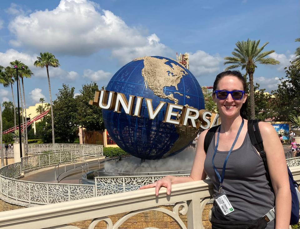 Lisa Galek smiling in front of Universal Orlando globe