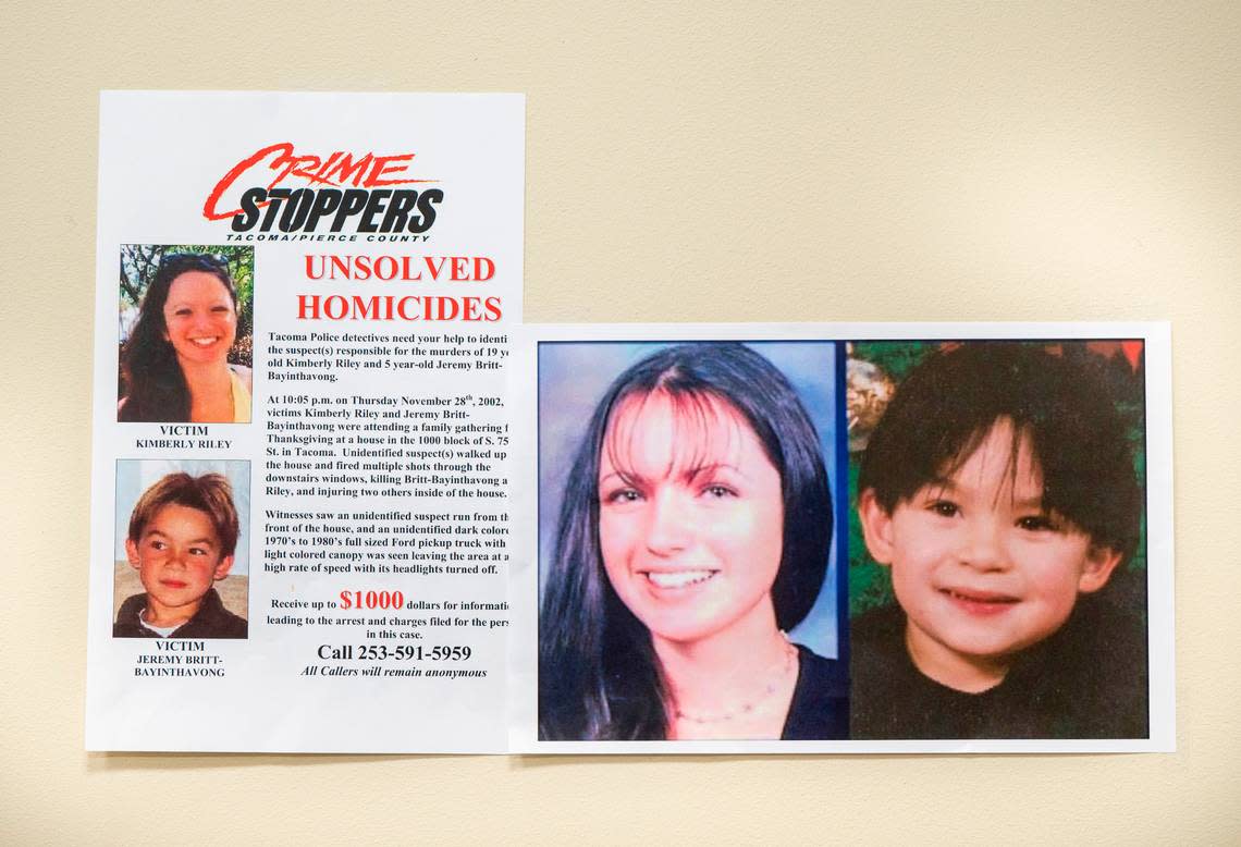 Images of Kimberly Riley, 19, left, and Jeremy Britt-Bayinthavong, 5, right, hang on a wall during an on-camera briefing asking people to come forward with information regarding their unsolved murders that occurred in 2002 on Thanksgiving after a shooting at a home in Tacoma’s South End, at the Tacoma Police Department Headquarters in Tacoma, Wash. on Nov. 3, 2022. Cheyenne Boone/Cheyenne Boone/The News Tribune