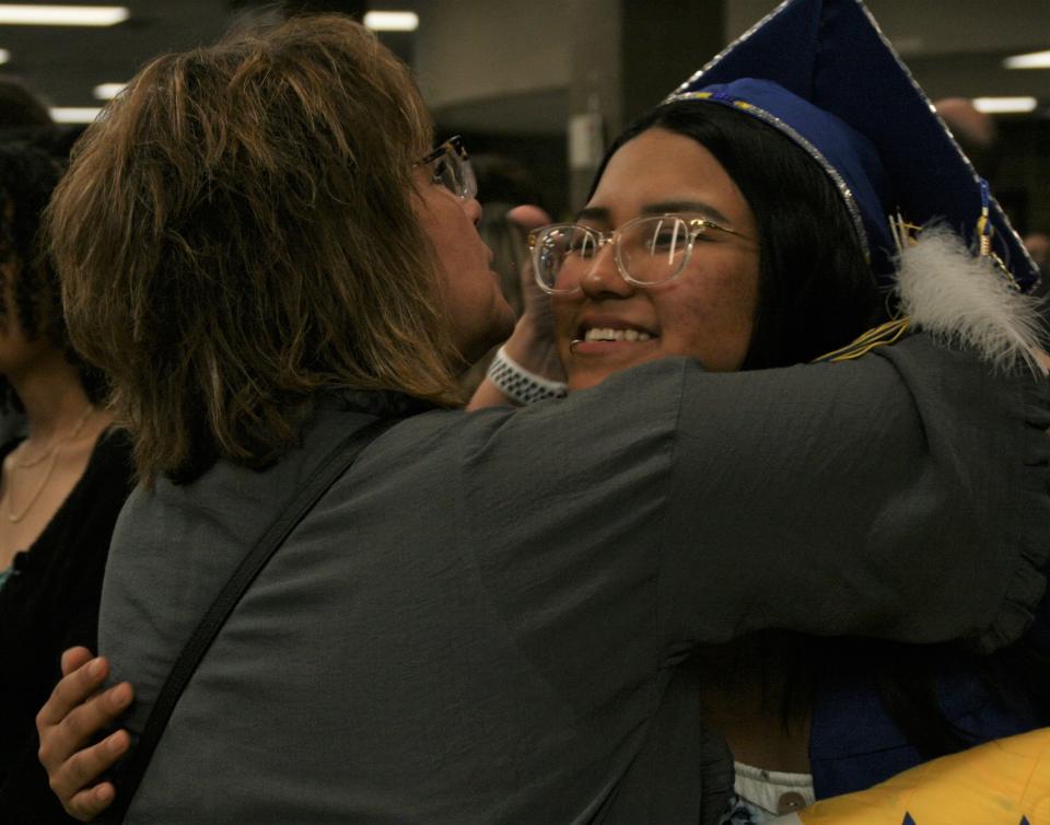 Central High School graduate Samantha Janis gets hug from Sandy Grebner after Sunday afternoon's graduation ceremony.