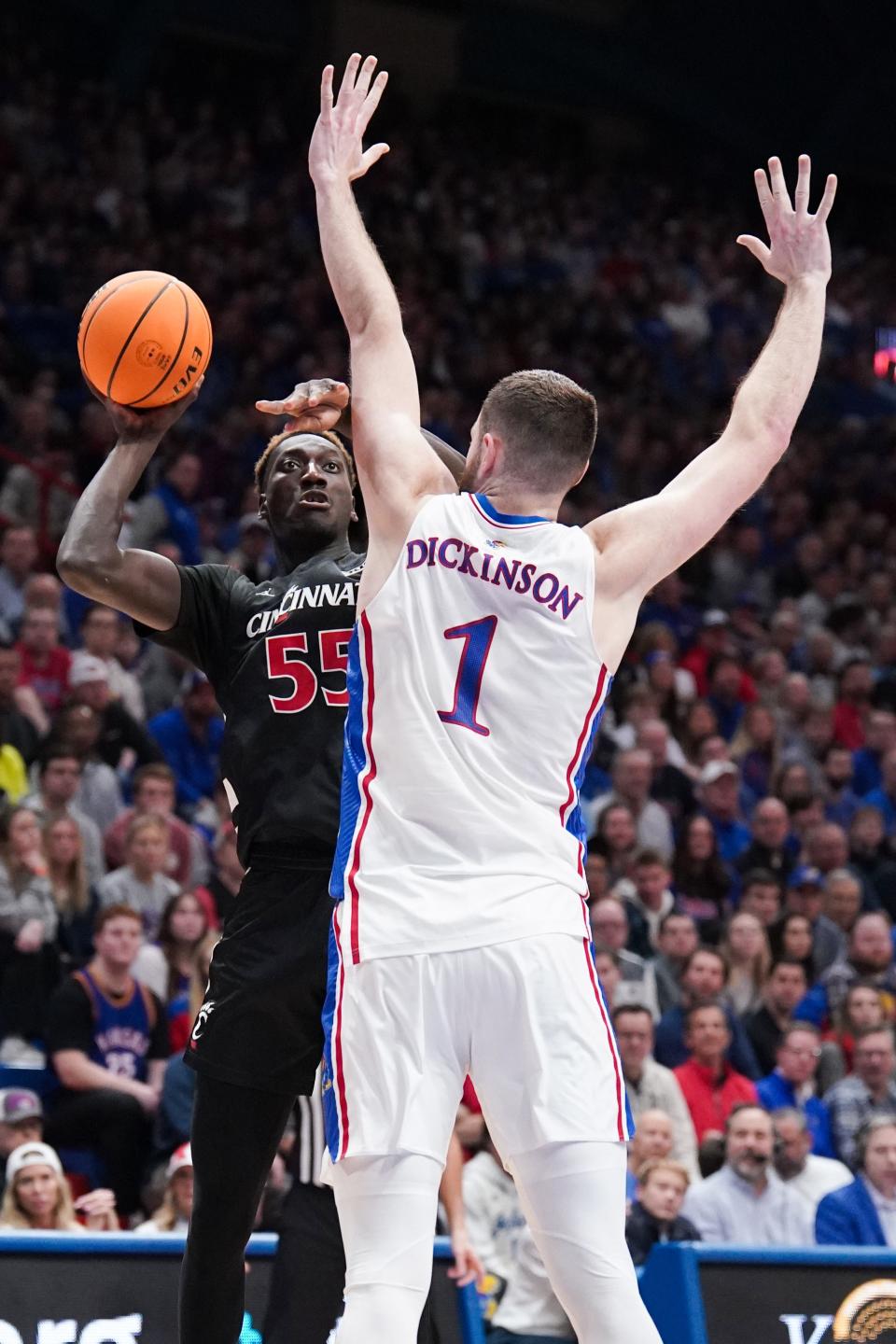 Cincinnati forward Aziz Bandaogo (55) shoots and is fouled by Kansas center Hunter Dickinson (1) during the first half of a basketball game Monday at Allen Fieldhouse.