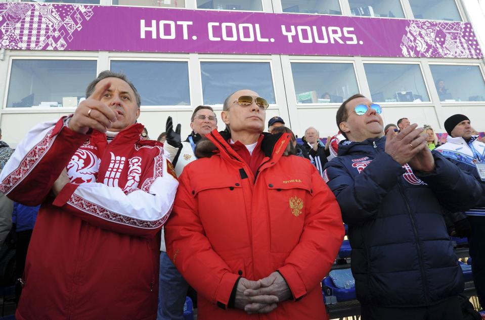 Russian President Putin and PM Medvedev watch the cross country skiing men's relay during the Sochi 2014 Olympic Winter Games at Laura Cross-Country Ski and Biathlon Center near Krasnaya Polyana